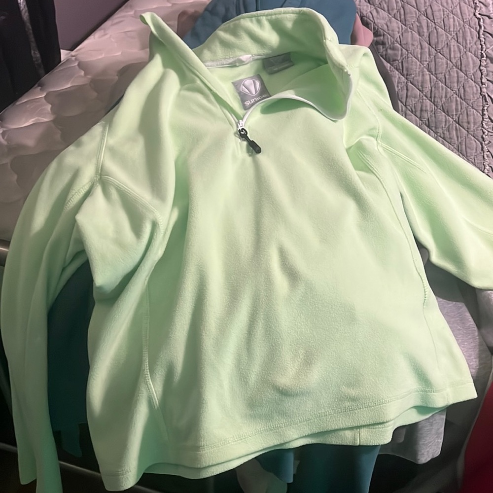 A nice fuzzy Sunice brand pullover jacket with a zipper in the front